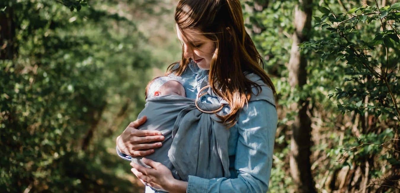 mother carrying newborn baby