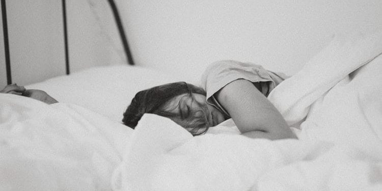 pregnant woman asleep on bed